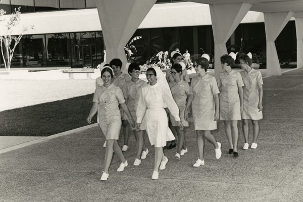 Black and white photo of school of nursing students walking together